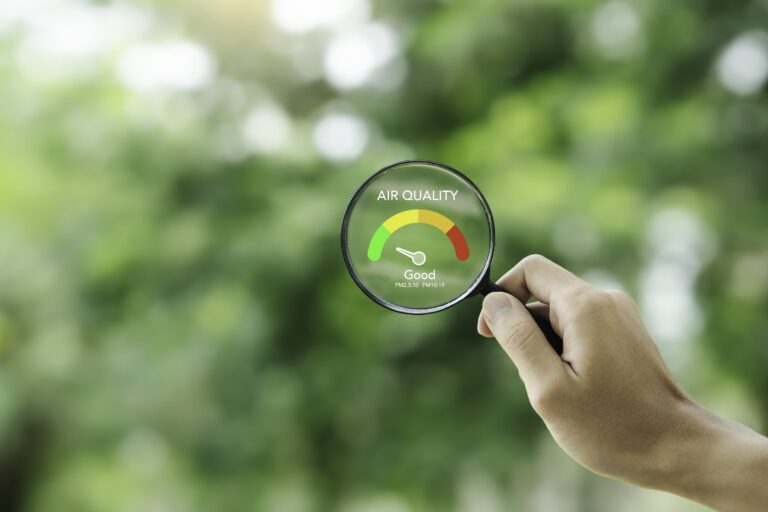hand-holding-magnifying-glass-check-good-air-quality-clean-outdoor-air-quality-safe-from-pollution-dust-pm-25-min